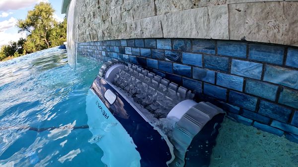 Aquabot REVA sitting beside my pool's waterfall after a cleaning cycle