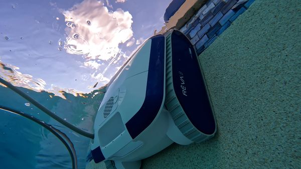Aquabot REVA cleaning along the pool waterline