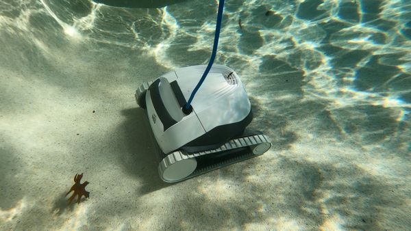 Dolphin E10 vacuuming leaves off the pool floor