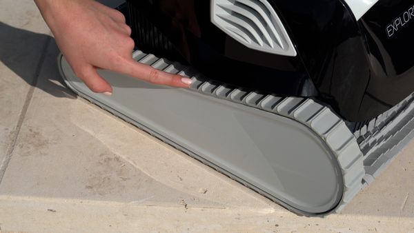 Hand touching the wheel tracks of the Dolphin Explorer E30