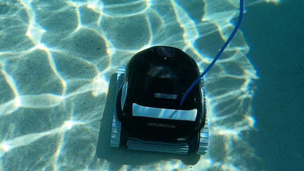 Dolphin Explorer E30 scrubbing a dirty section of pool floor