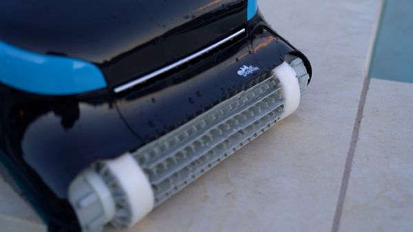 Close-up of the Dolphin Nautilus CC Plus brush on the pool wall