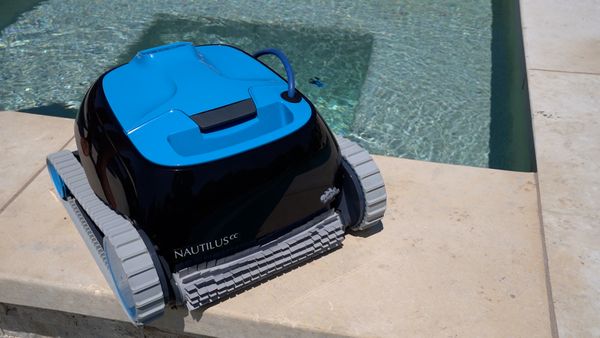 Dolphin Nautilus CC resting poolside after a cleaning run