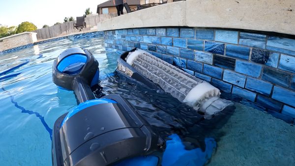 Dolphin Premier scrubbing the waterline with a person watching in the background