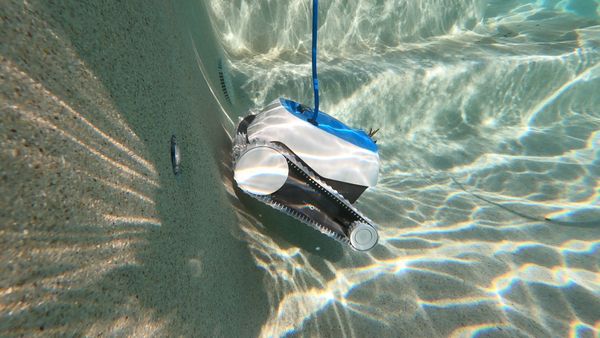 Dolphin Proteus DX3 pushing off the pool wall mid-cycle