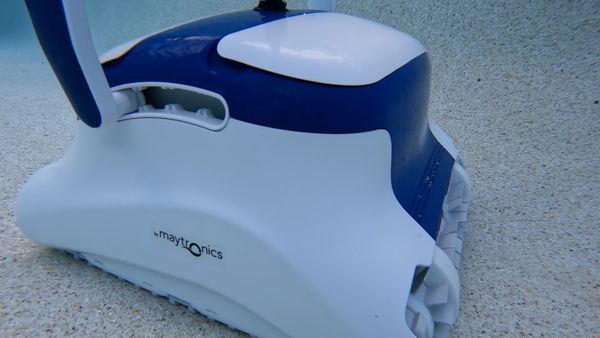 Rear side view of the Dolphin Sigma cleaning the pool floor