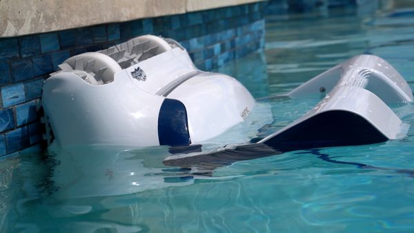 Close-up of the Dolphin Sigma scrubbing blue tile at the waterline